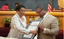 Commissioner Jordan presenting plaque