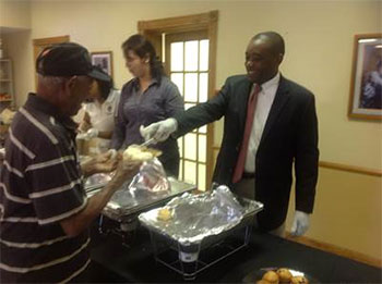 Commissioner Jean Monestime, District 2, serves residents at the “Breakfast with the Commissioner Jean Monestime, District 2, serves residents at the “Breakfast with the