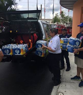 Commissioner Diaz unloading bottled water