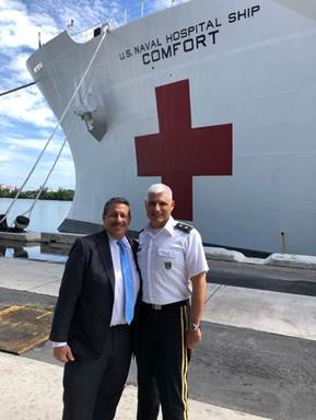 Commissioner Diaz on the dock with the captain of the USNS Comfort