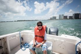 Baynanza T-shirt design winner Tristan Gude enjoys a boat tour of Biscayne Bay