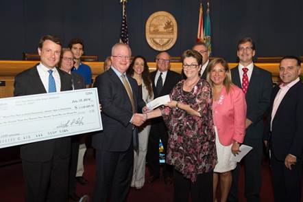 Representatives from ConEdison Solutions present Miami-Dade County with $1.135 million check.