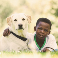 Boy smiling holding a dog
