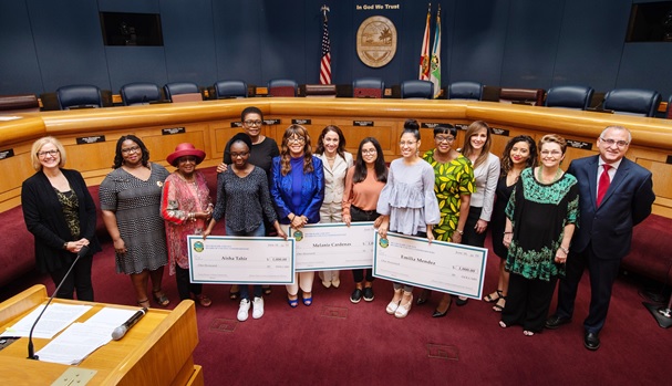County Commission Chairwoman Audrey Edmonson, Vice Chairwoman Rebeca Sosa, Commissioner Eileen Higgins, and Commissioner Esteban Bovo, Jr., along with Commission for Women members, present the Young Women Achiever scholarship checks