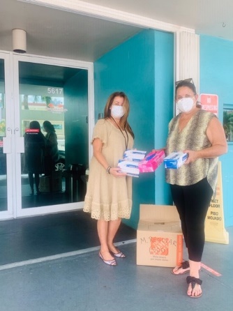 Staff distributing face masks
