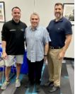 Interfaith Program Director Teo Noboa ad Public Defender Carlos Martinez and board member Rev. Evelio Vilches