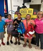 Commissioner Eileen Higgins with students holding backpacks