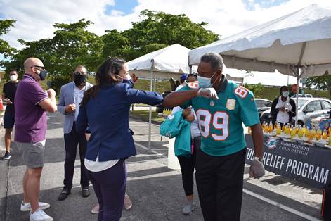 Commissioner Cohen Higgins and Miami Dolphins Vice President Nat Moore