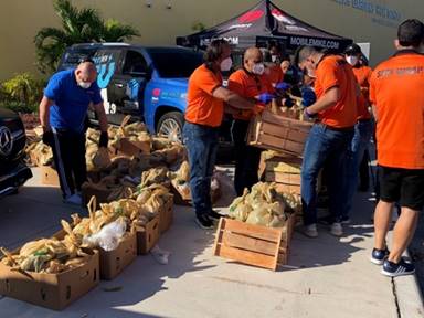 Commissioner Pepe Diaz helps distributes food