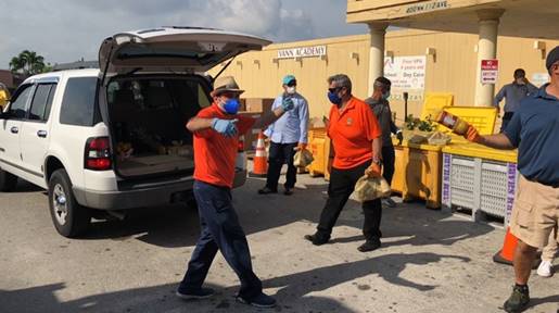 Commissioner Pepe Diaz helps distributes food