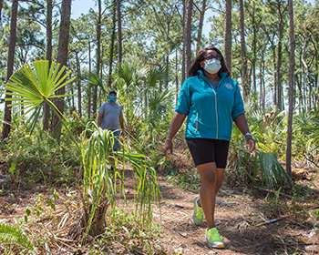 A woman and a man on a walking path in a park