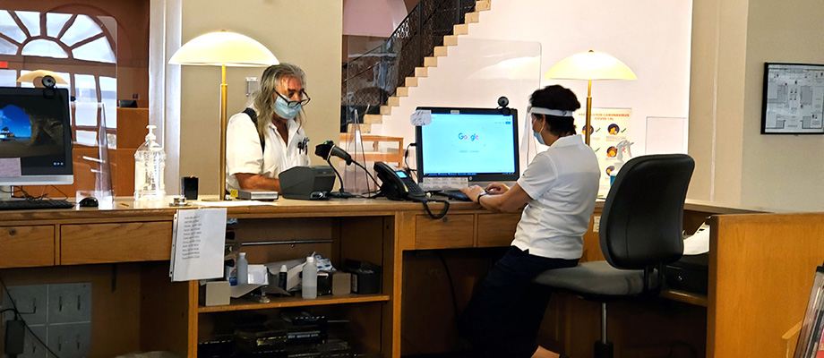 People wearing facial coverings at a library