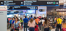 Lots of people walking around inside of Miami International Airport