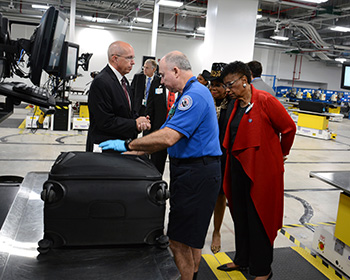 Commissioner Barbara Jordan checking out the new baggage handling system