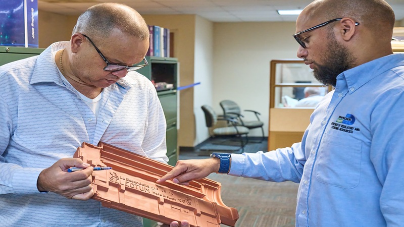 Two men looking at part