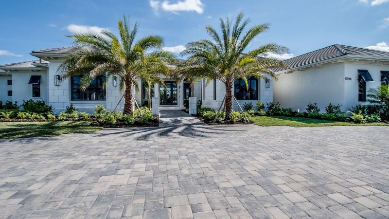 image of a home with a large paver driveway out front