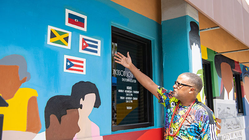 Man standing in front of Jacksons Soul Food restaurant 
