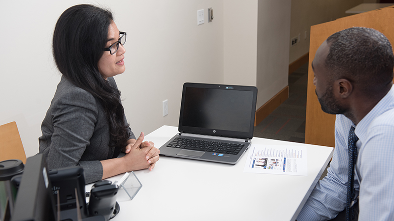 Man and woman having a chat over a desk