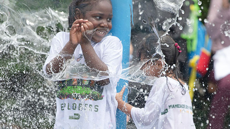 Kids playing by water fountain