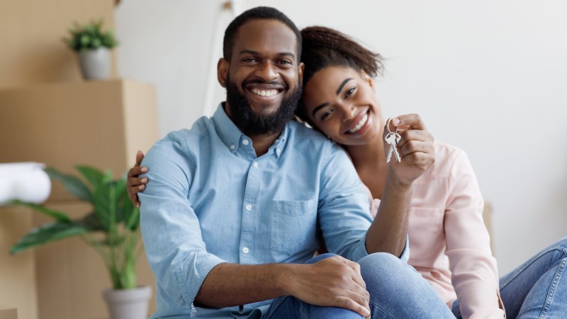 Man and woman holding house keys
