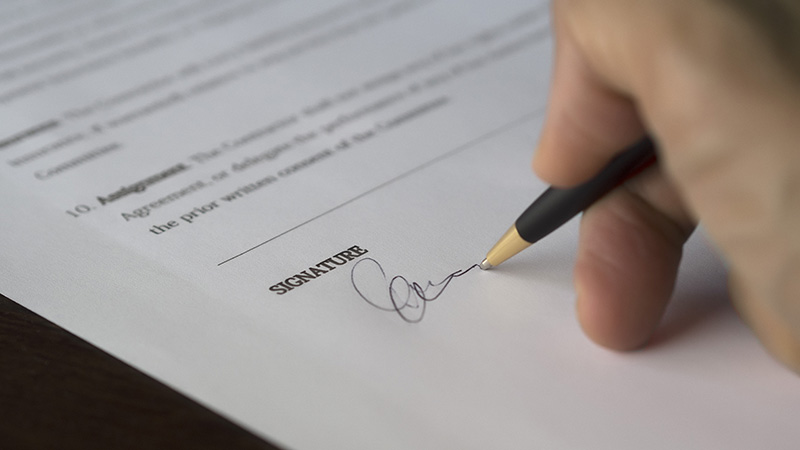 Person signing a contract