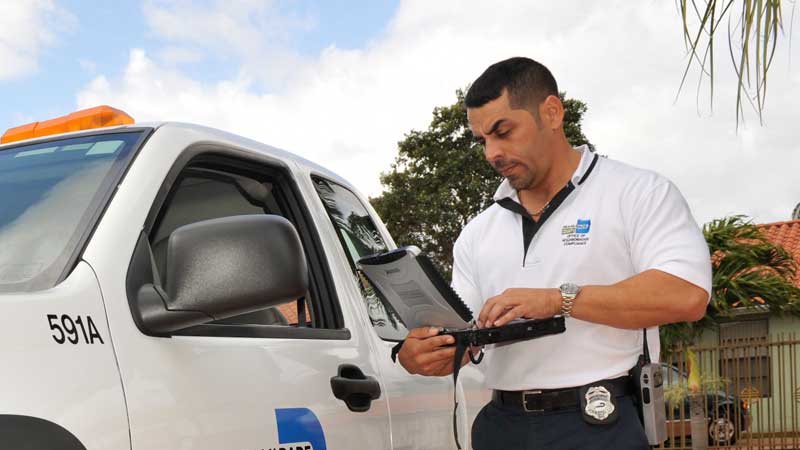 inspector standing next to Miami-Dade County truck