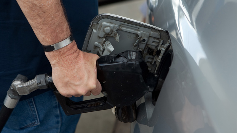 Man pumping gas into vehicle