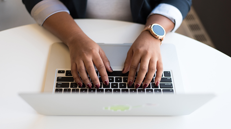 Close up shot of woman's hands using a laptop