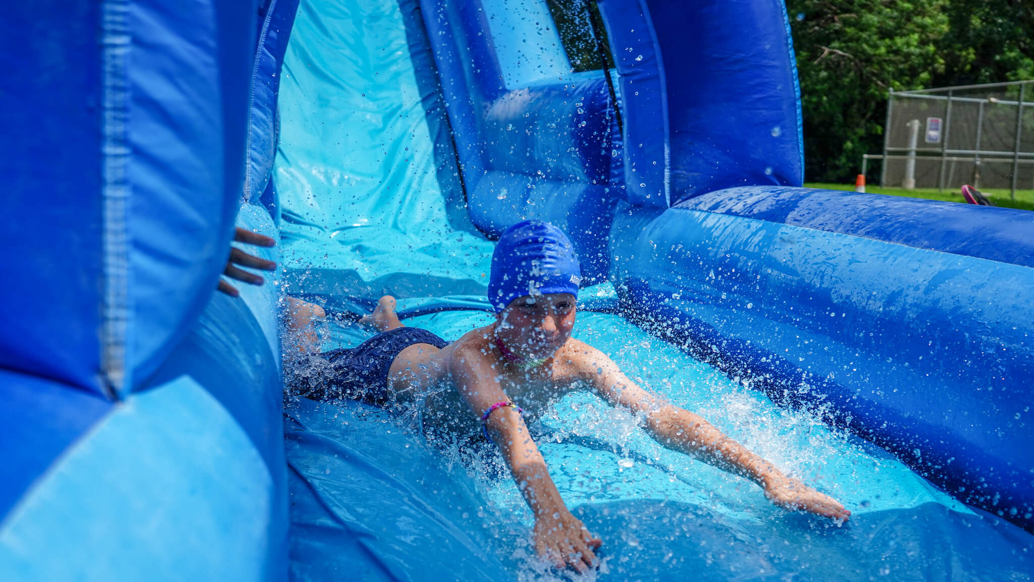 Camp Owaissa Bauer campers enjoying the inflatable water slide.