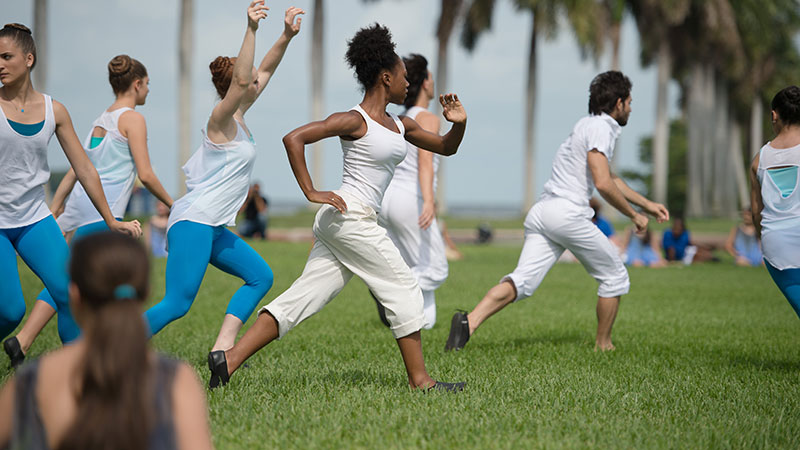 Yoga students exercising in a park