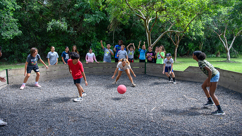 Summer campers playing in the Camp Owaissa Bauer gaga ball pit.