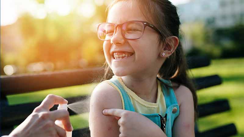 girl getting mosquito repellent 