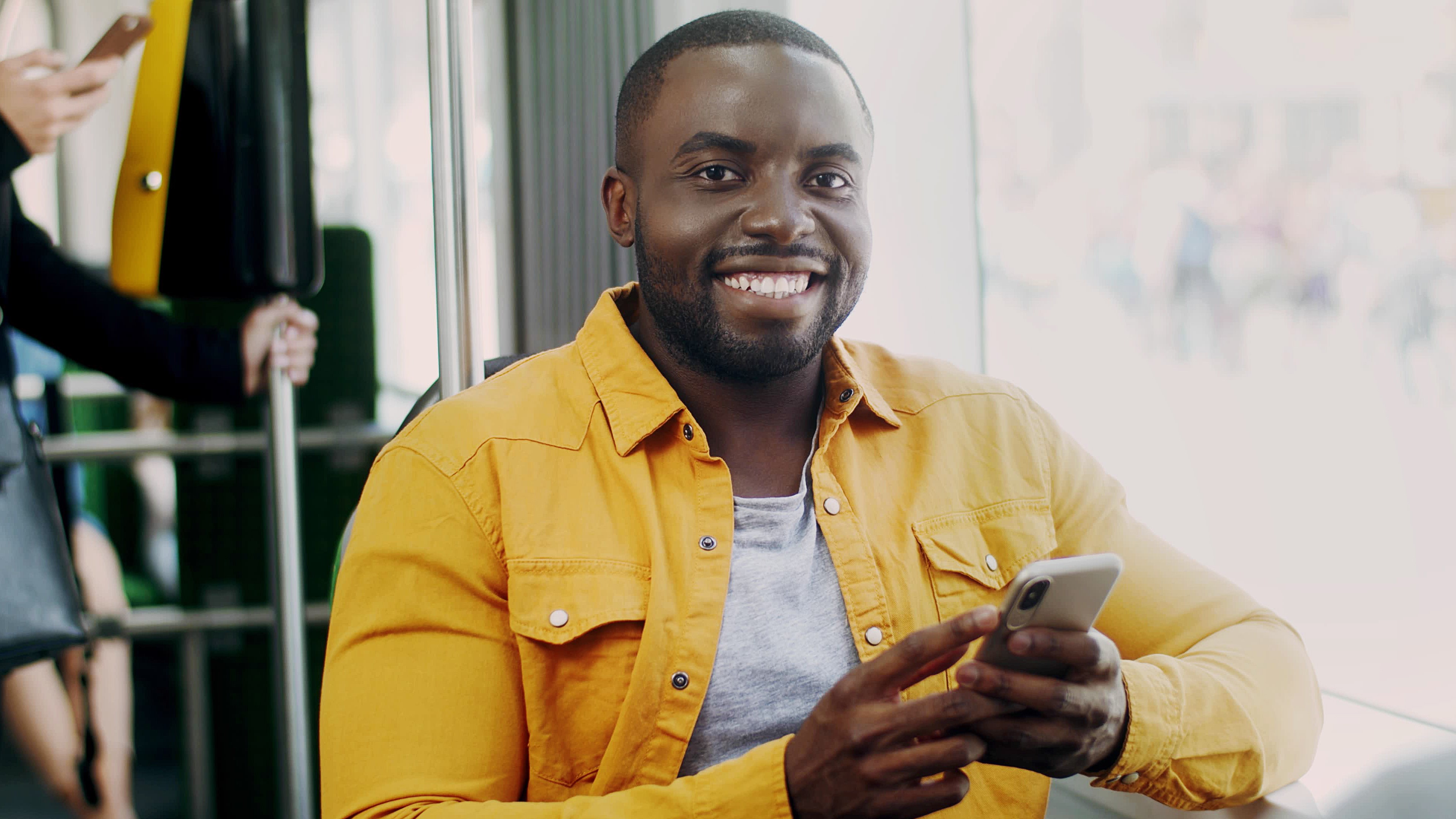 image of young black male smiling on the bus