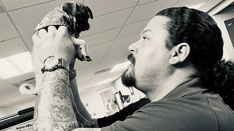 Jerry Estevez holding a puppy