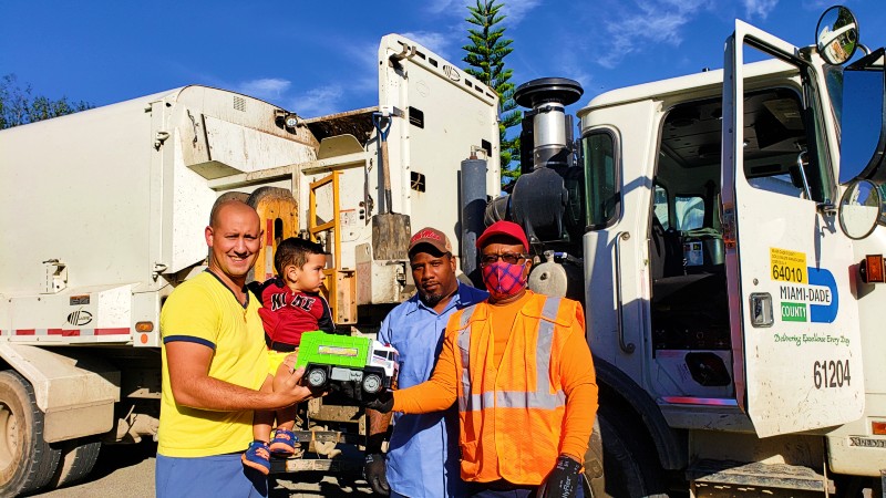 Father and son with Solid Waste employees