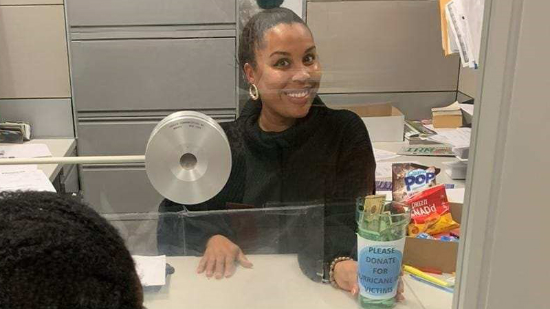 Tax Collector staff member holding a donation container