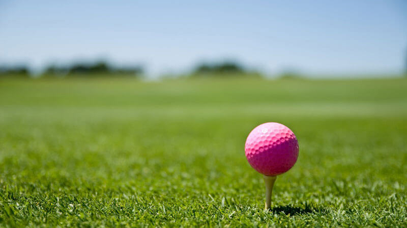 Pink golf ball on a tee