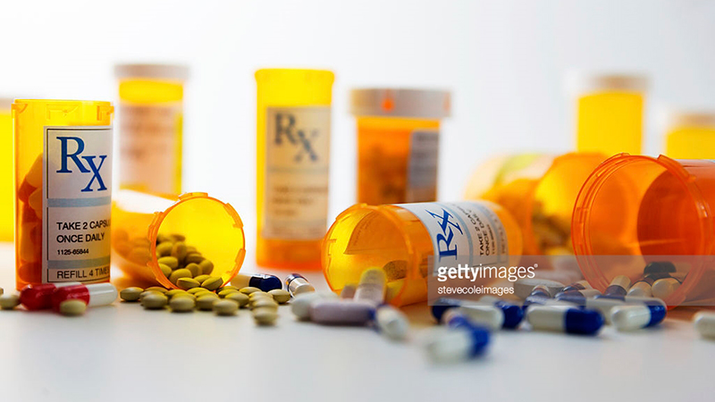 prescription drugs lined up and scattered on surface