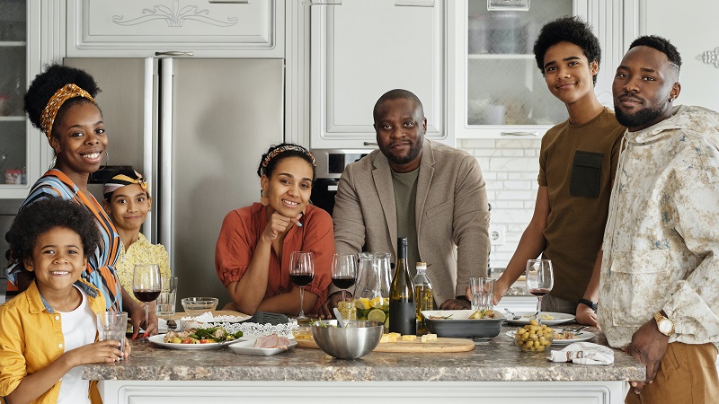 Image of a family gathering in the kitchen.