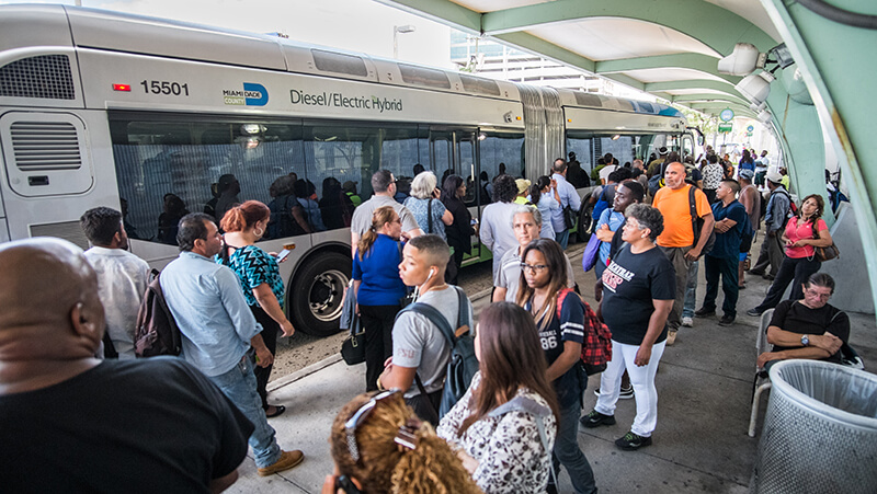 People entering and exiting a Metrobus.