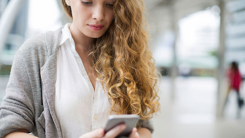 Woman on phone signing up for Miami-Dade alerts