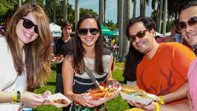 Group of friends enjoying seafood at Deering Seafood Festival.
