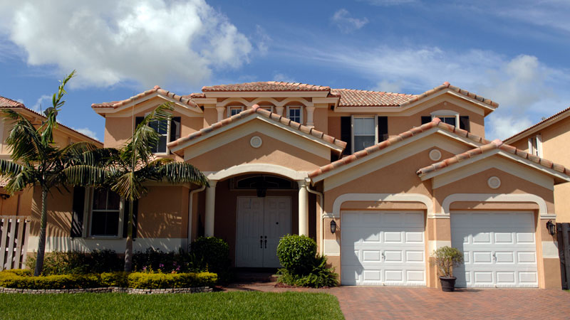 2-story peach colored home with white trim 