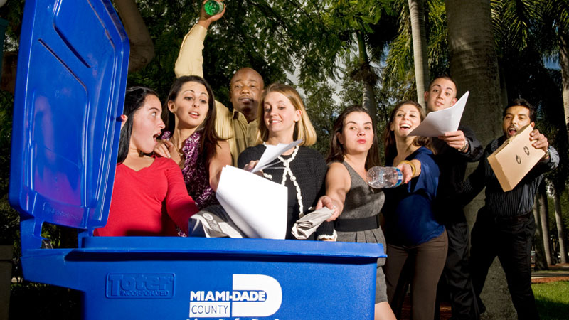 people putting recycling items in recycle bin