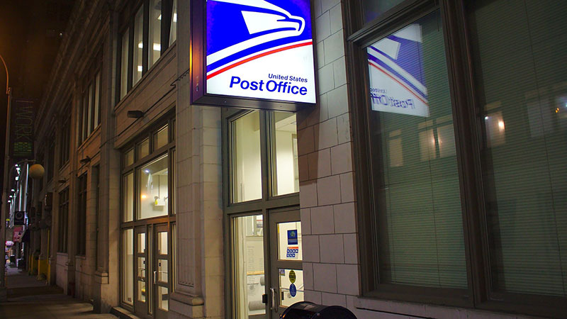 Outside of United States Post Office at night.