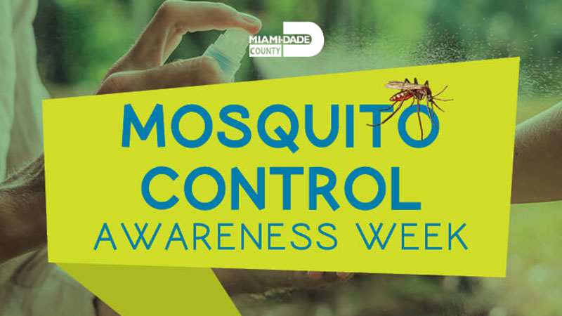 close up photo of hand spraying mosquito spray and sign Mosquito Awareness