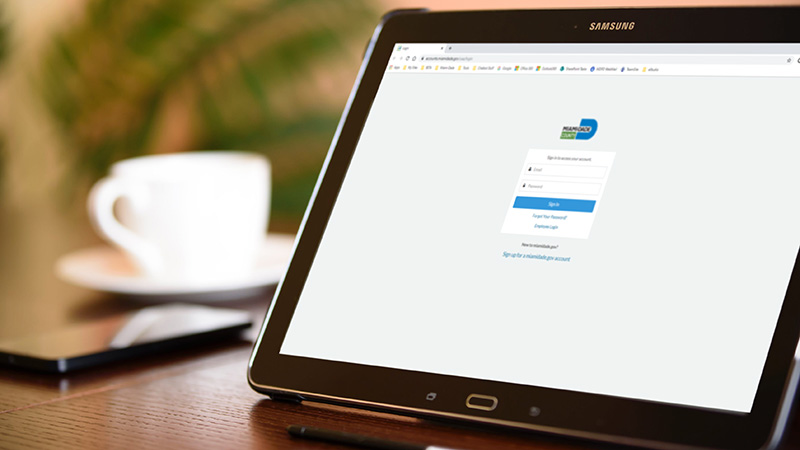 Miamidade.gov login displayed on laptop.