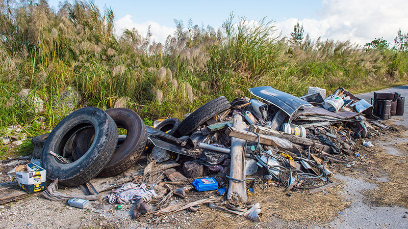 Trash illegally dumped on the side of the road