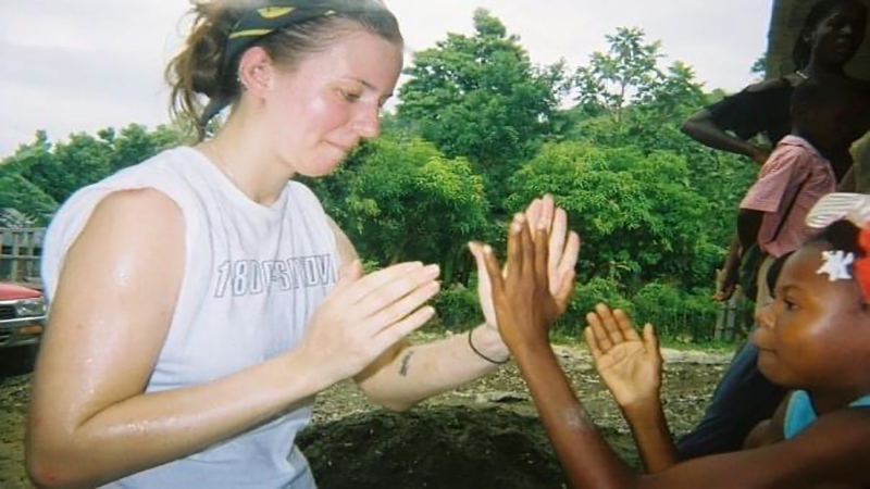 Criminalist 2 Erin M. Wilson playing patty cake with a child