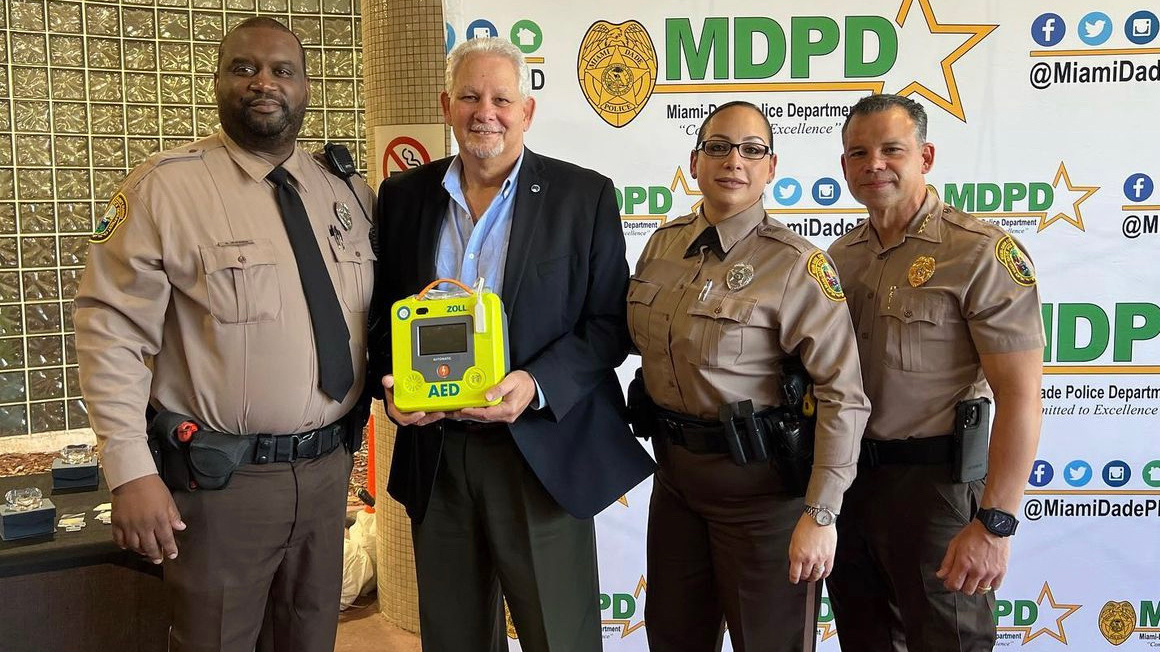 Tony Quintero with officers who saved his life and MDPD Director Alfredo "Freddy" Ramirez.